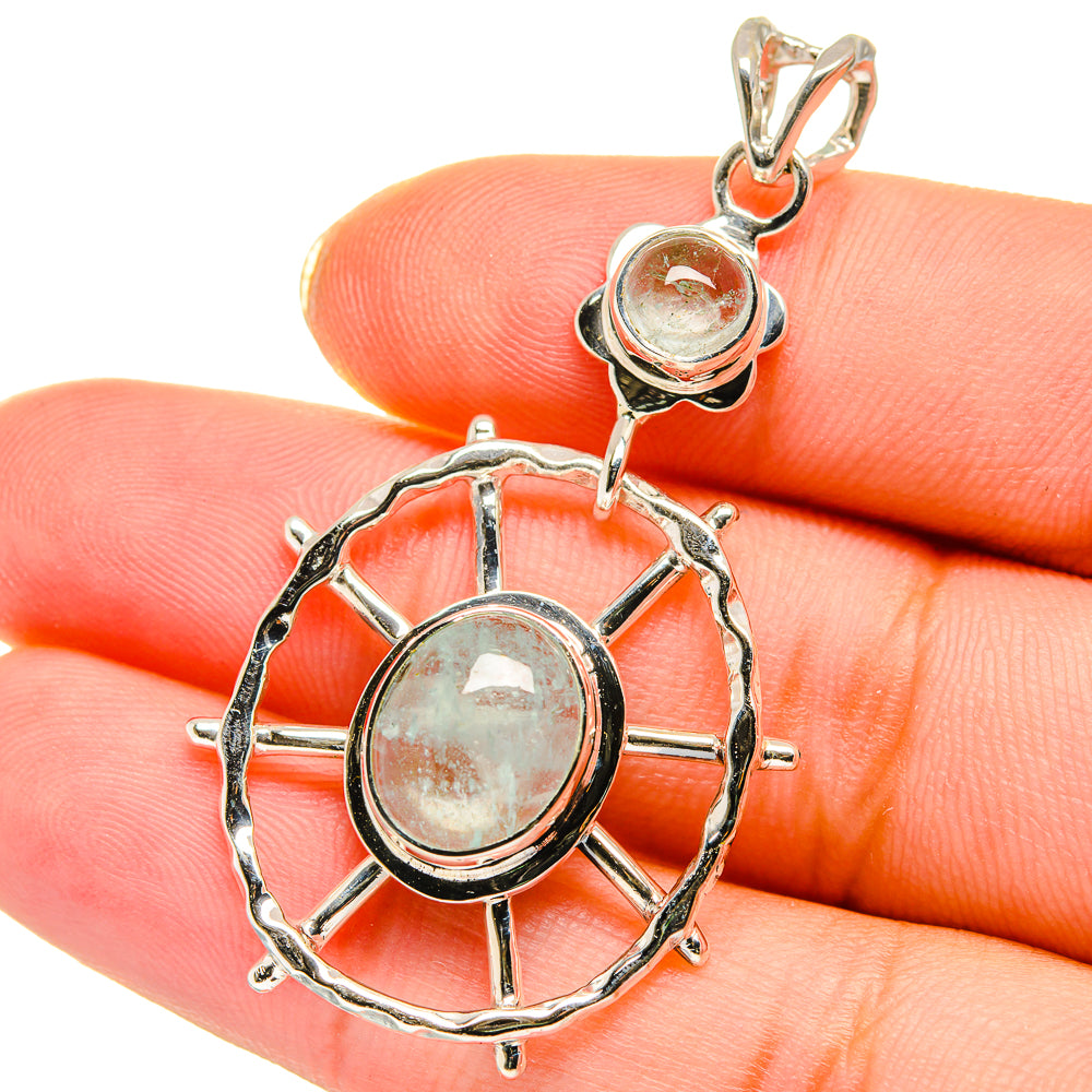 Sterling silver pendant close-up with two aquamarine cabochons and linked openwork rings