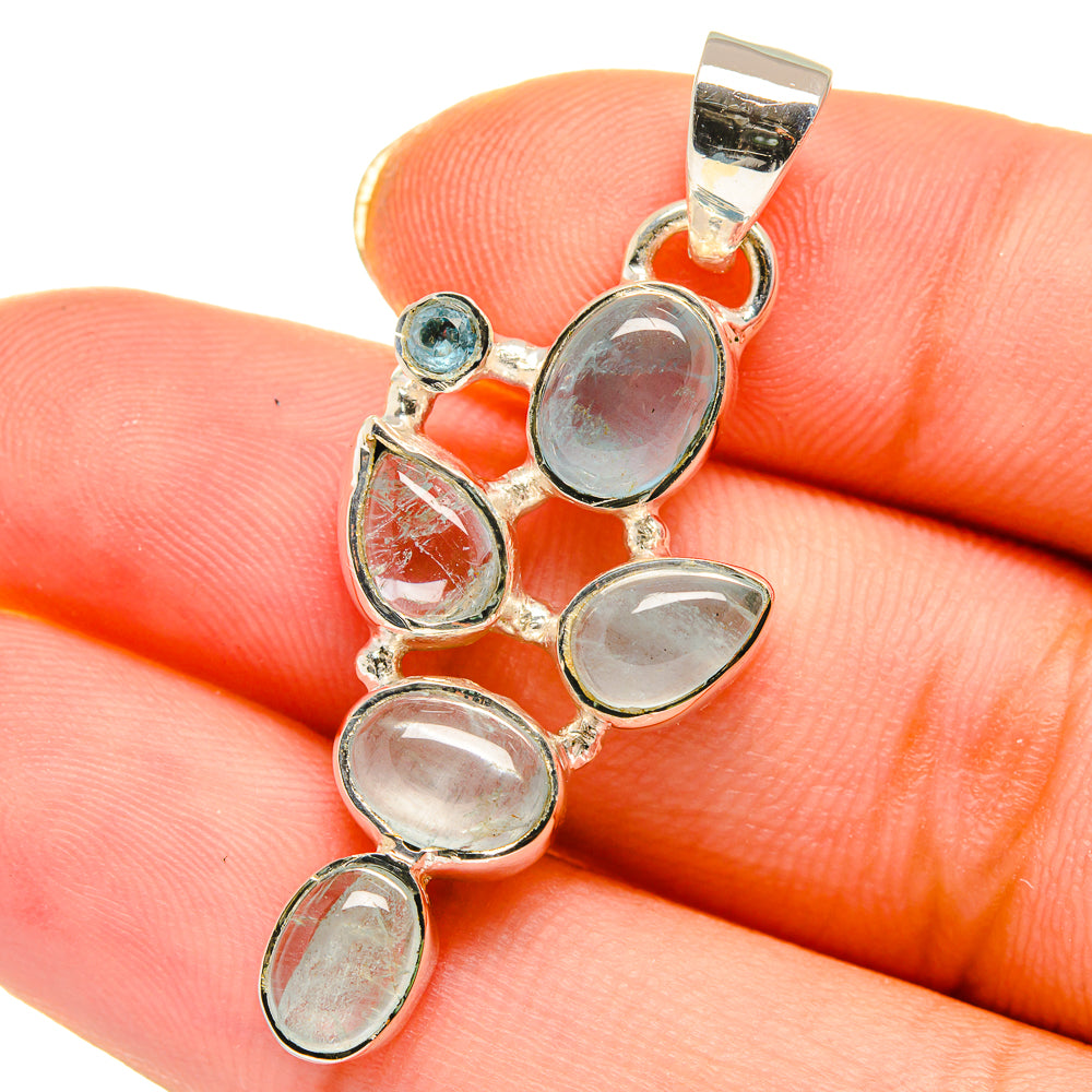 Sterling silver pendant with oval blue and clear gemstones, top loop bail