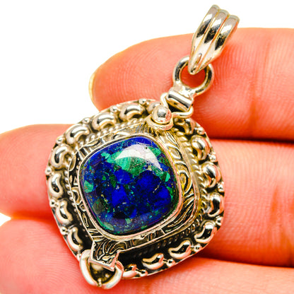 Sterling silver pendant with oval blue gemstone cabochon, ornate frame and bail loop