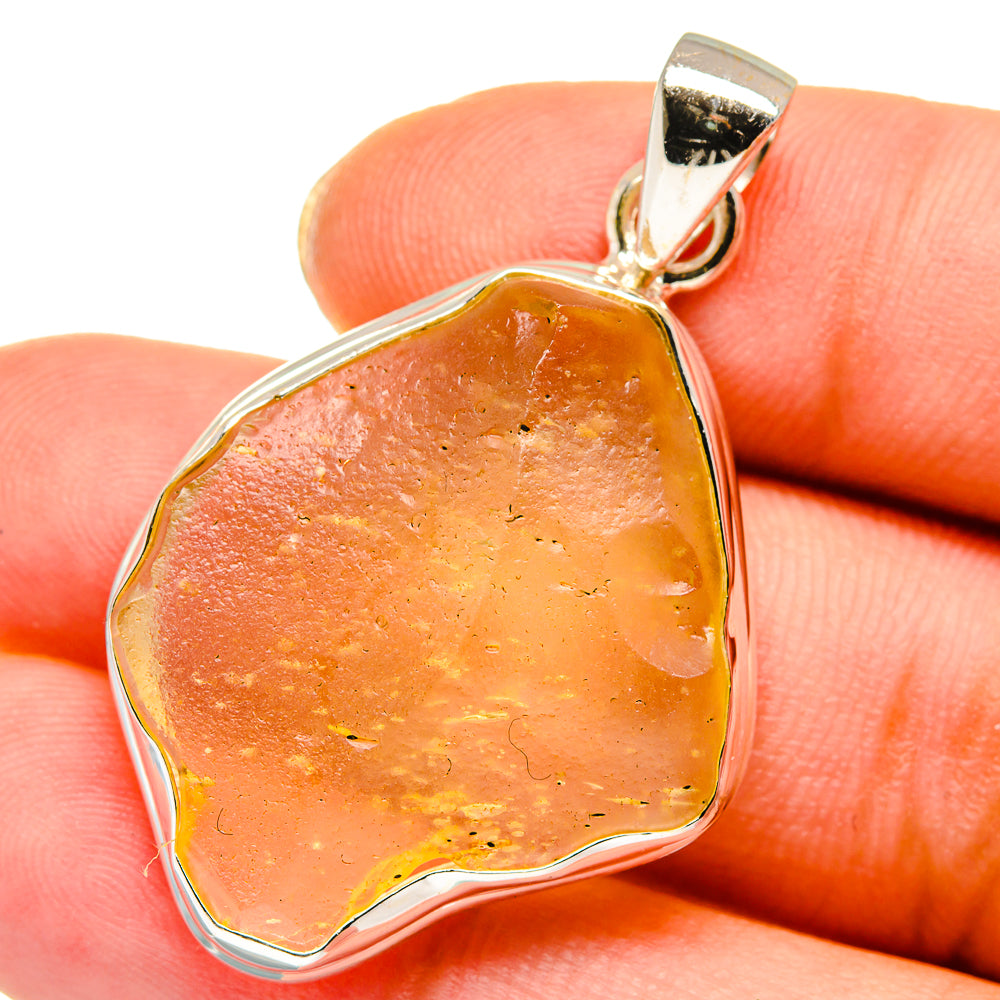 Amber glass pendant with sterling silver bezel and loop bail, faceted teardrop shape