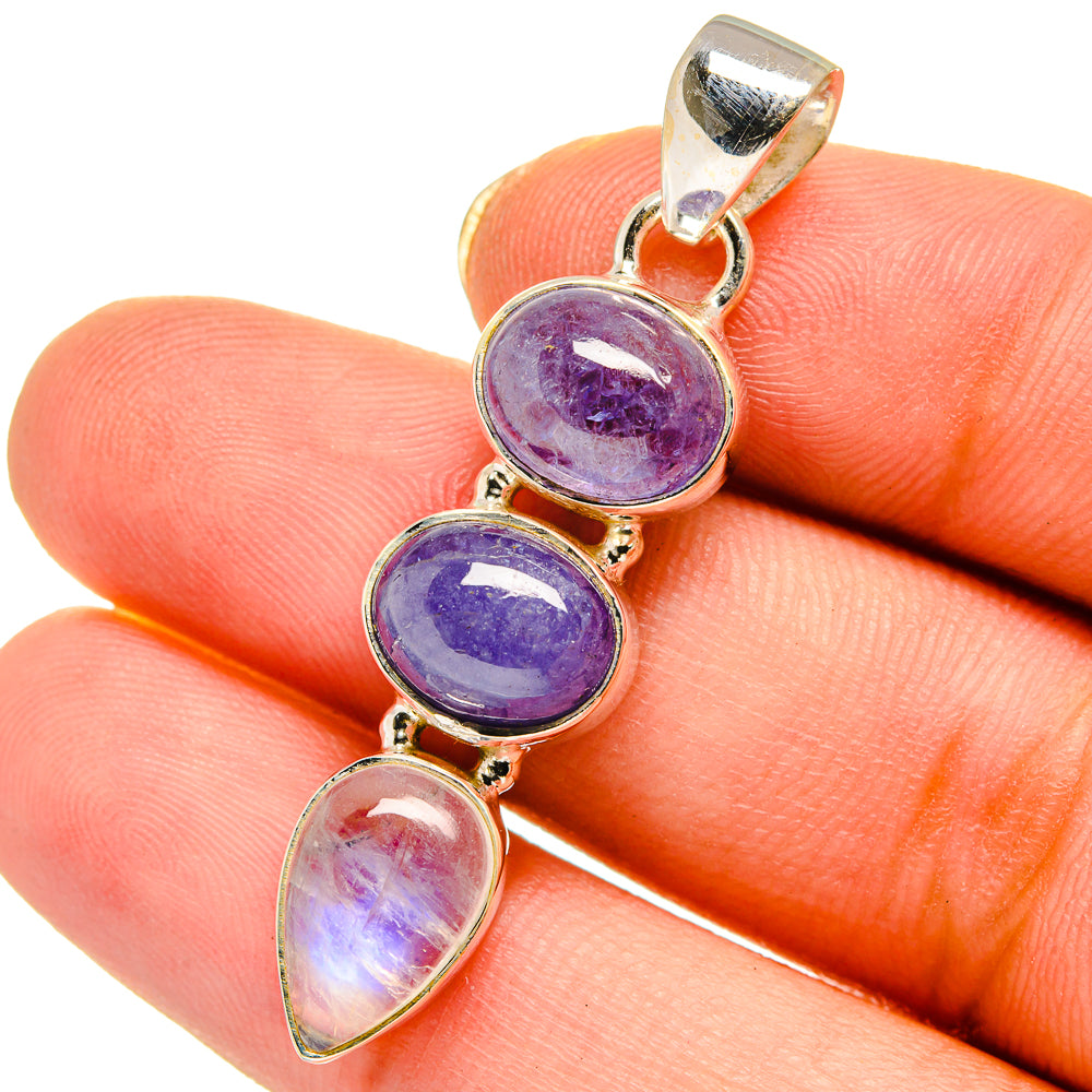 Sterling silver pendant with three oval stones in purple and iridescent white, bail top