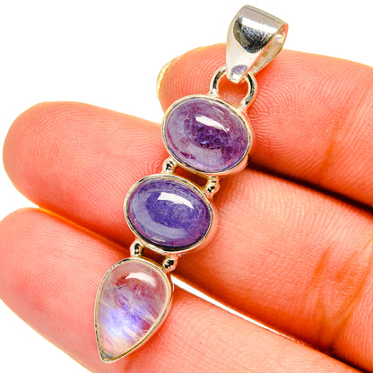 Sterling silver pendant with three oval stones in purple and iridescent white, bail top
