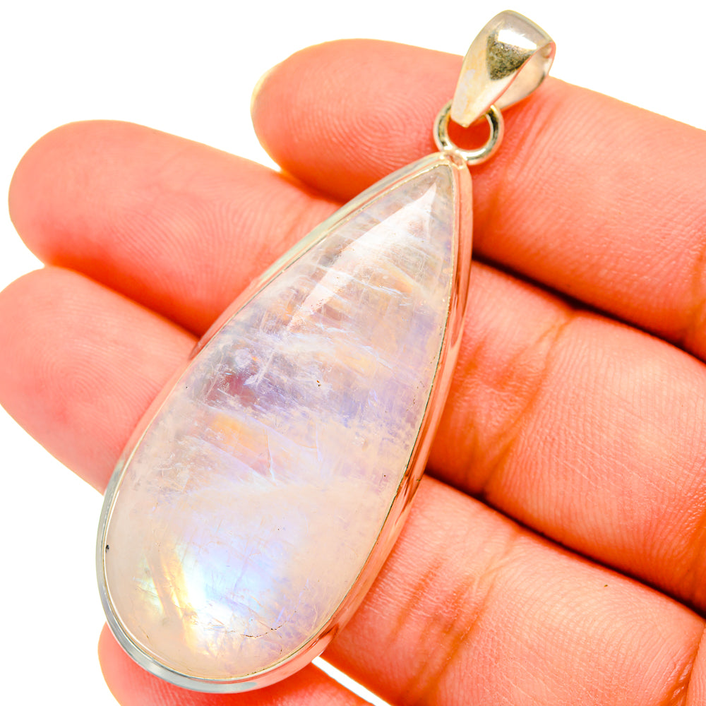 Teardrop moonstone pendant, pearly iridescent glow with gold bail on fingertips
