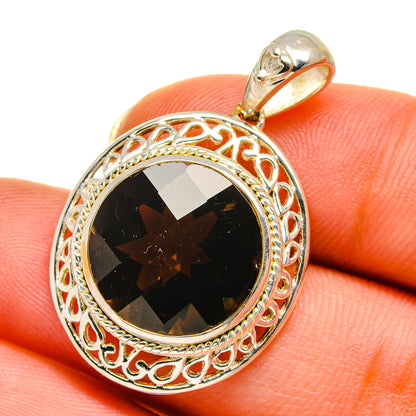 Round sterling silver pendant with dark smoky quartz in filigree bezel, worn on finger
