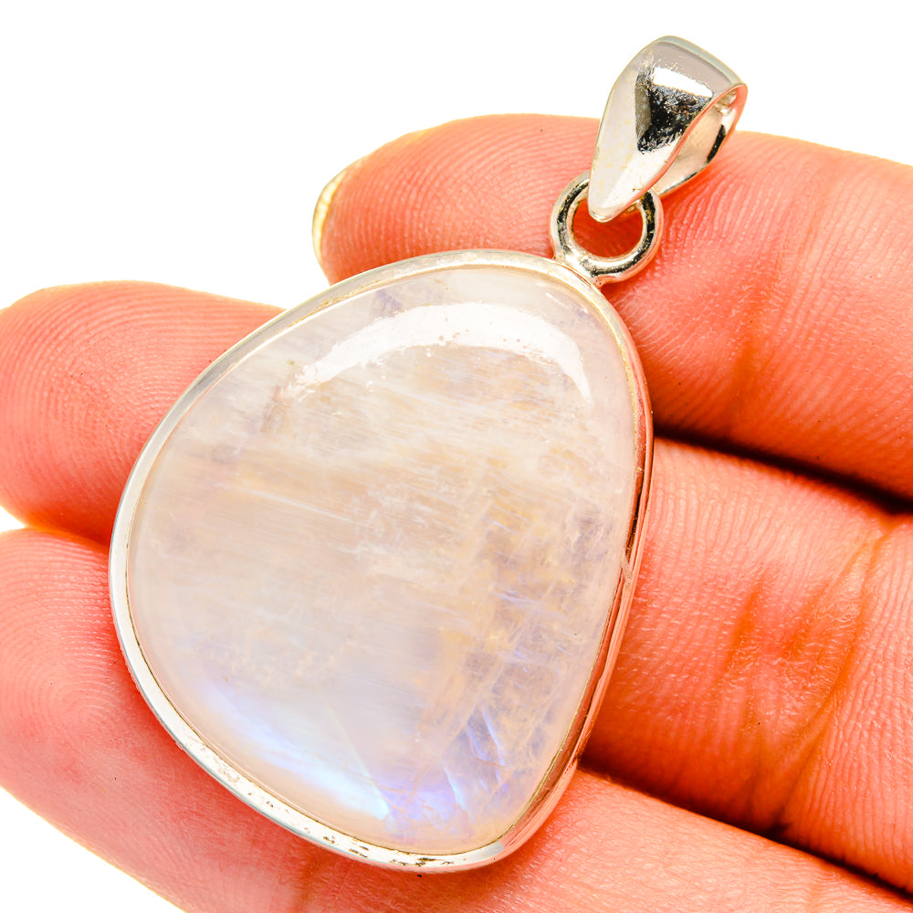 Pear-shaped moonstone pendant with iridescent opal cabochon in silver bezel