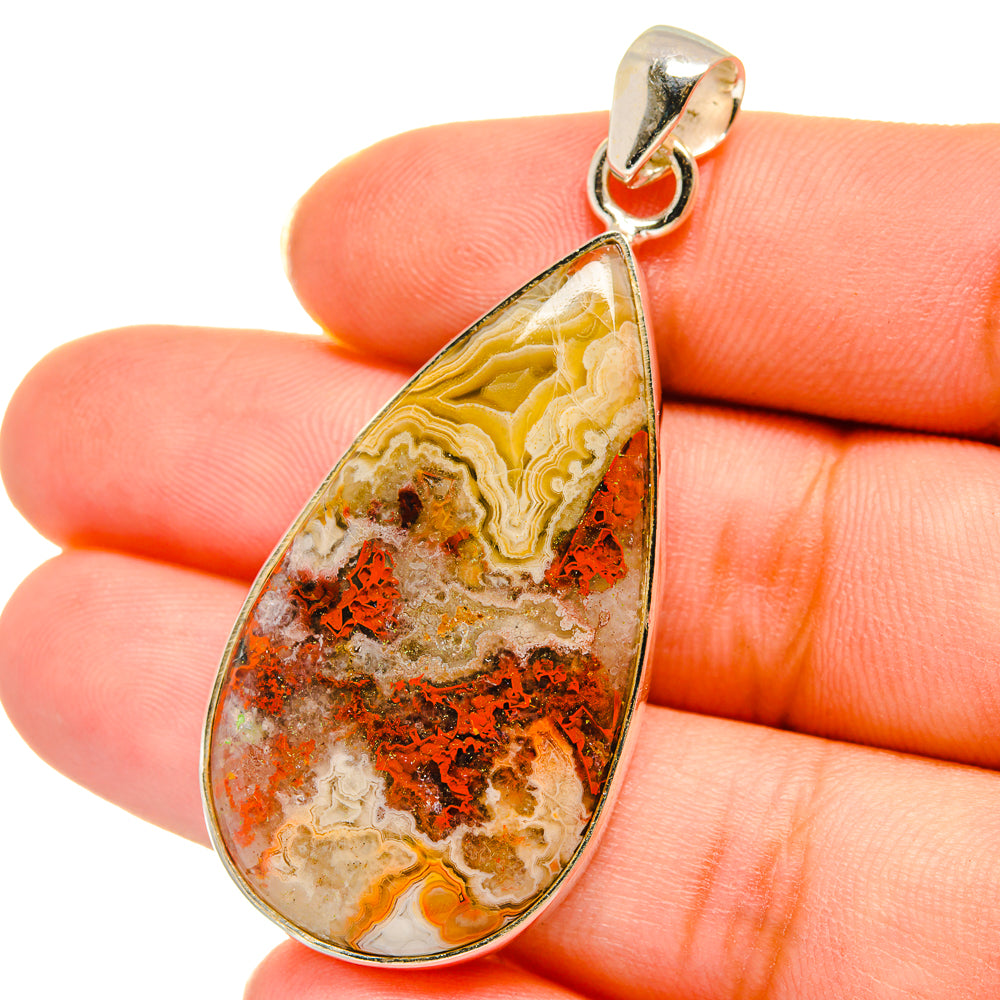 Crazy lace agate teardrop pendant close-up on 925 sterling silver bail; orange and cream