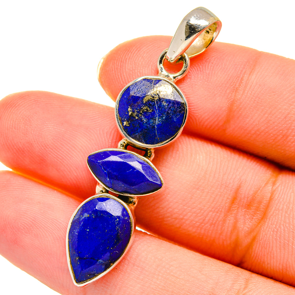 Lapis lazuli teardrop pendant with blue stones and gold-tone bail