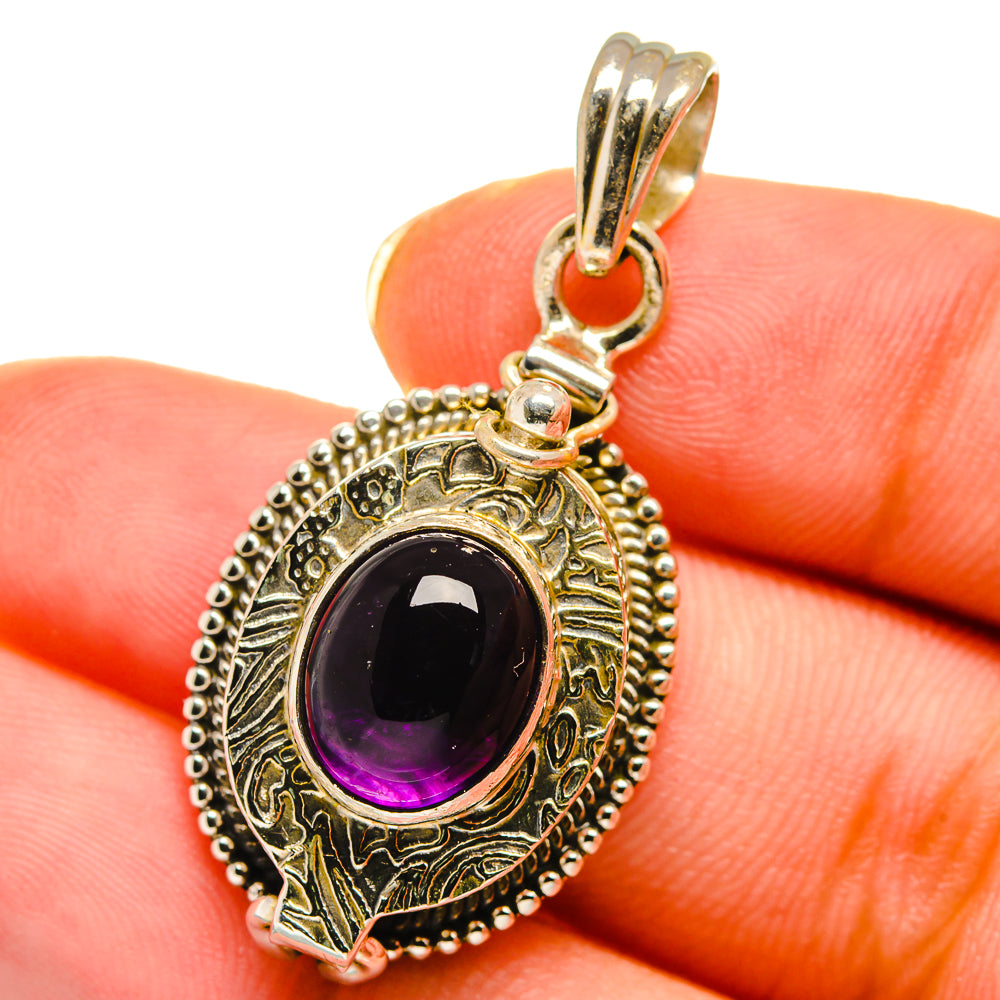 Sterling silver amethyst oval pendant with engraved frame and purple center stone