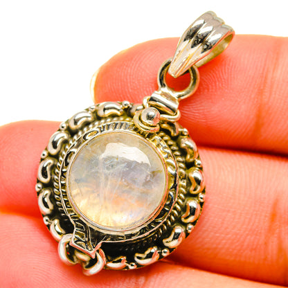 Close-up moonstone pendant showing round cabochon and ornate frame with bail