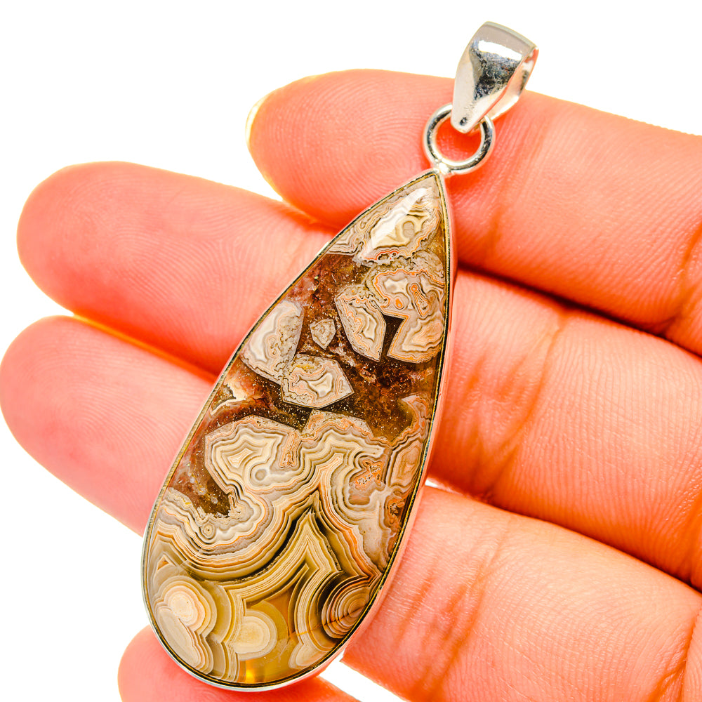 Teardrop agate pendant, close-up of golden-brown banded stone in sterling silver bail