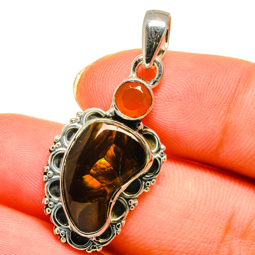 Sterling silver fire agate pendant close-up with orange round cabochon and oval stone