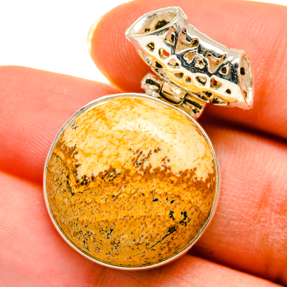 Round amber picture jasper pendant with sterling silver bezel and decorative bail detail