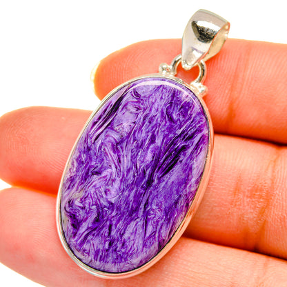 Oval purple charoite pendant with silver-tone bezel and top bail