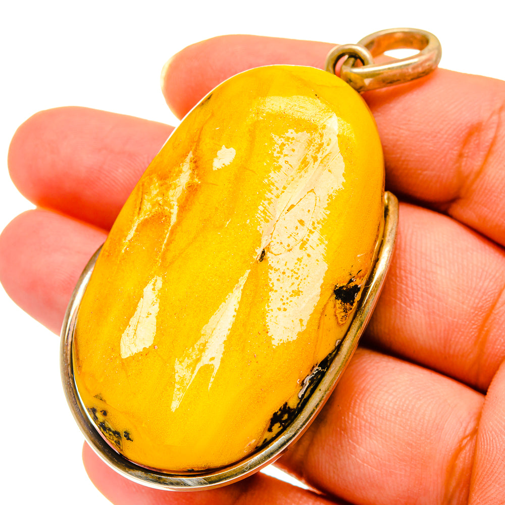 Oval amber pendant with polished 925 sterling silver bezel and loop bail