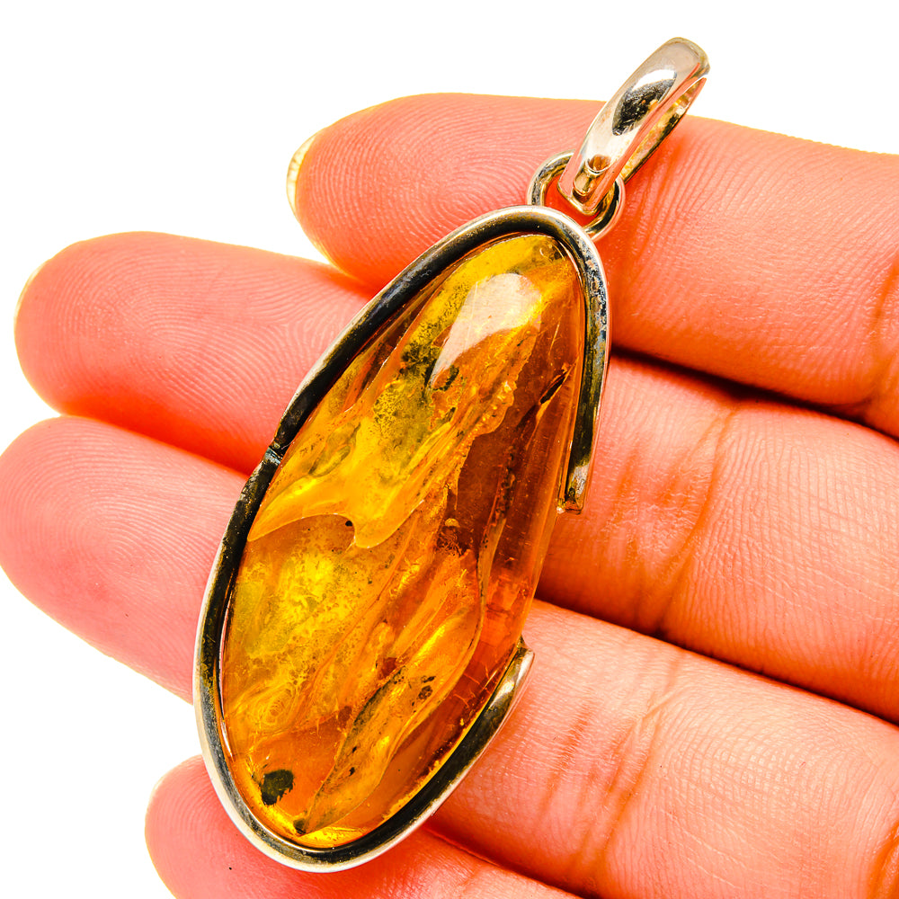 Amber teardrop pendant in 925 sterling silver with gold-toned stone in an oval bezel