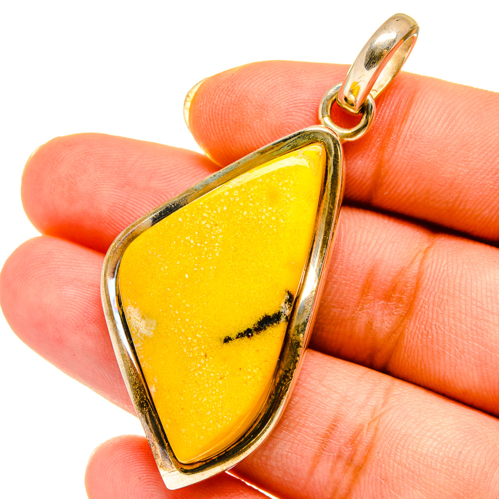 Amber teardrop pendant on hand, gold-tone 925 sterling silver frame