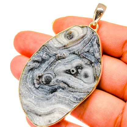Sterling silver teardrop druzy pendant with blue-gray desert stone pattern, gold bezel