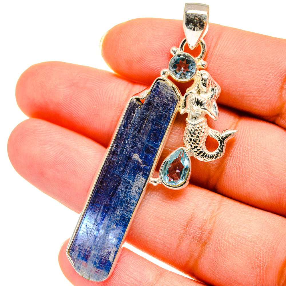Mermaid charm pendant in silver with rough blue stone, teal round, and teardrop stones.
