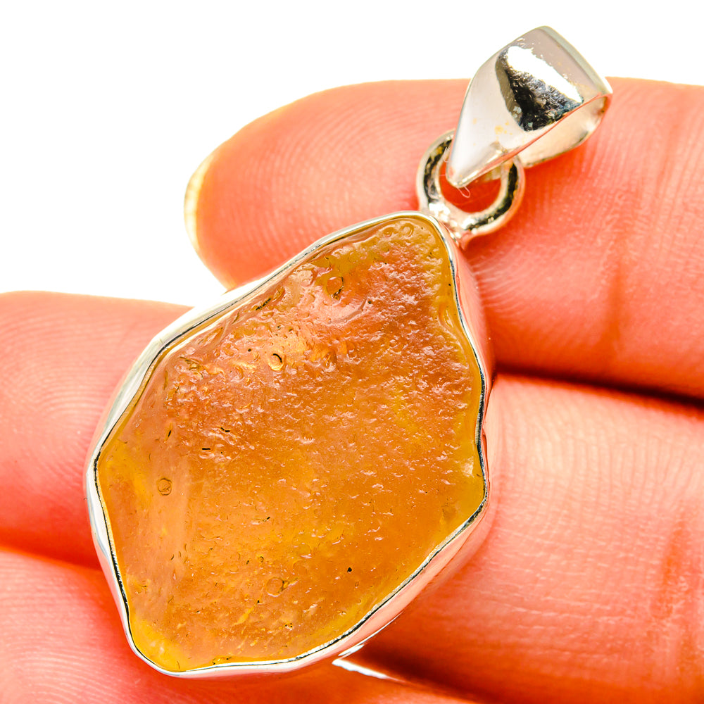 Teardrop Desert Glass pendant with silver bezel and loop bail, amber orange
