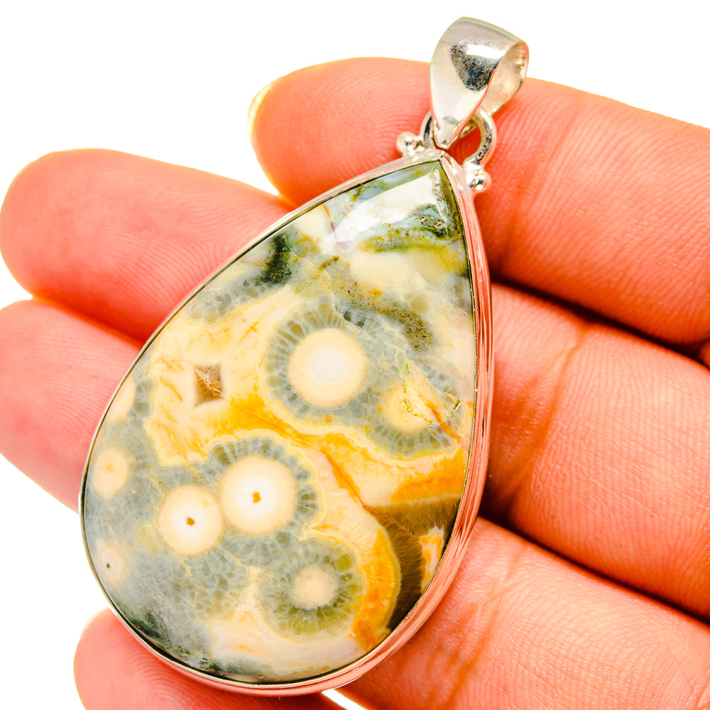 Teardrop ocean jasper pendant on fingers, 925 sterling silver bail, multicolor stone