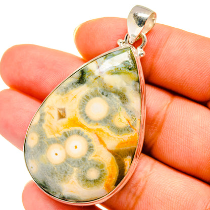 Teardrop ocean jasper pendant on fingers, 925 sterling silver bail, multicolor stone