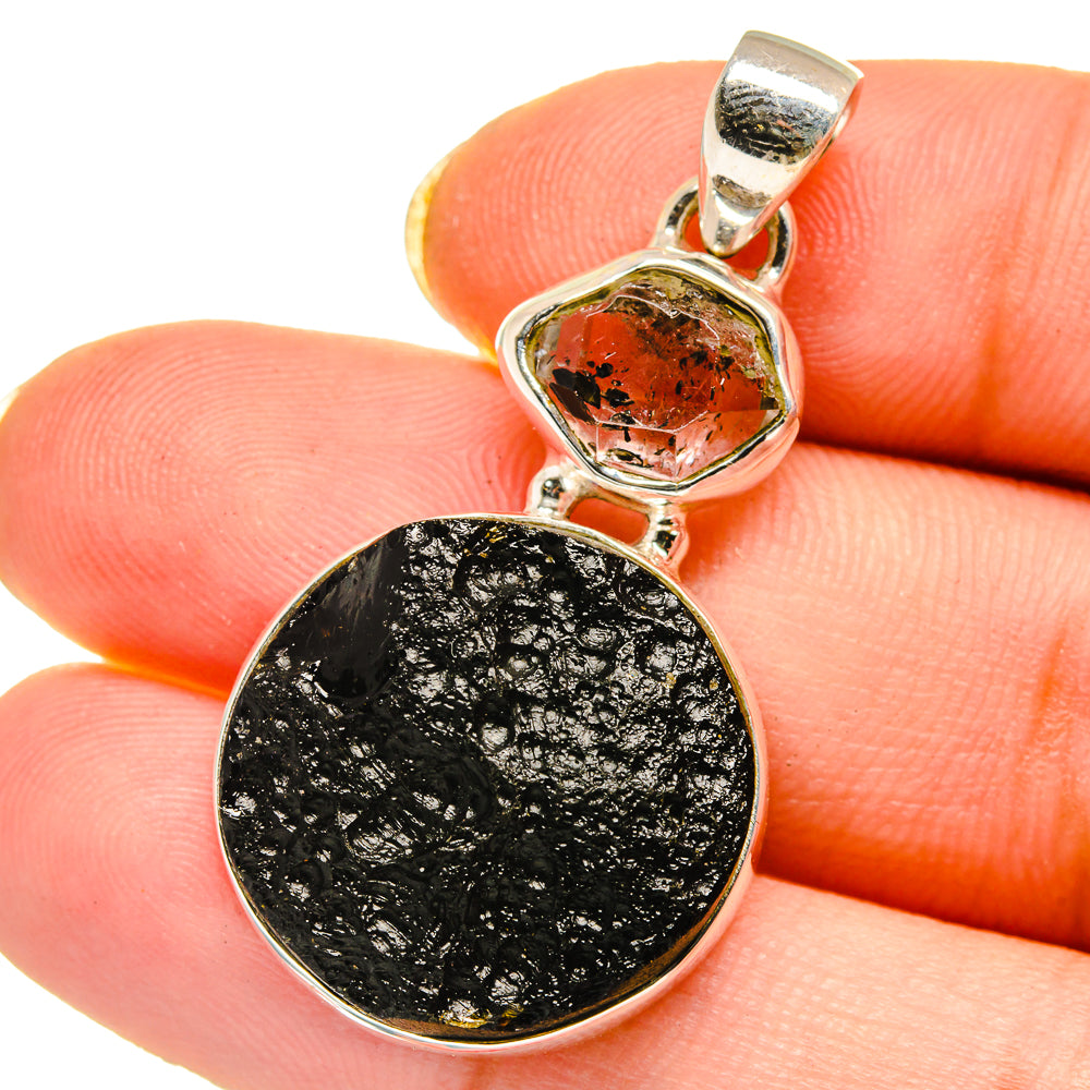 Sterling silver tektite pendant with black oval stone and small orange crystal top
