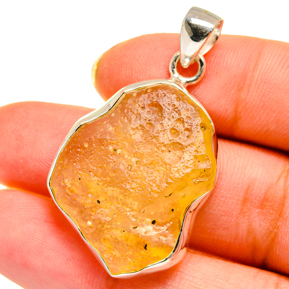 Amber irregular desert glass pendant with sterling silver bail and scalloped bezel