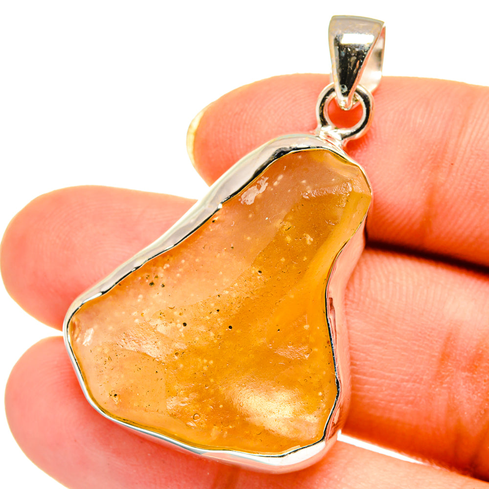 Heart-shaped desert glass pendant, amber-gold stone in sterling silver bezel