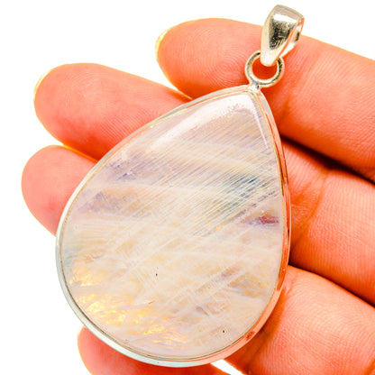 Iridescent teardrop moonstone pendant with silver bail, close-up view