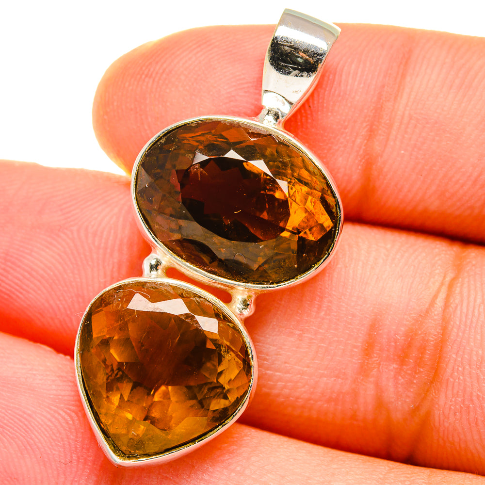 Sterling silver pendant with two oval amber citrine gemstones, faceted double drop setting