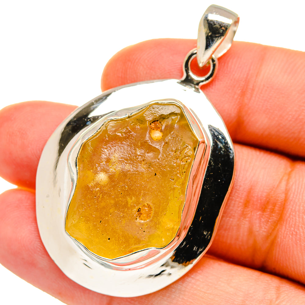 Sterling silver pendant with teardrop bezel and rough amber glass inlay.