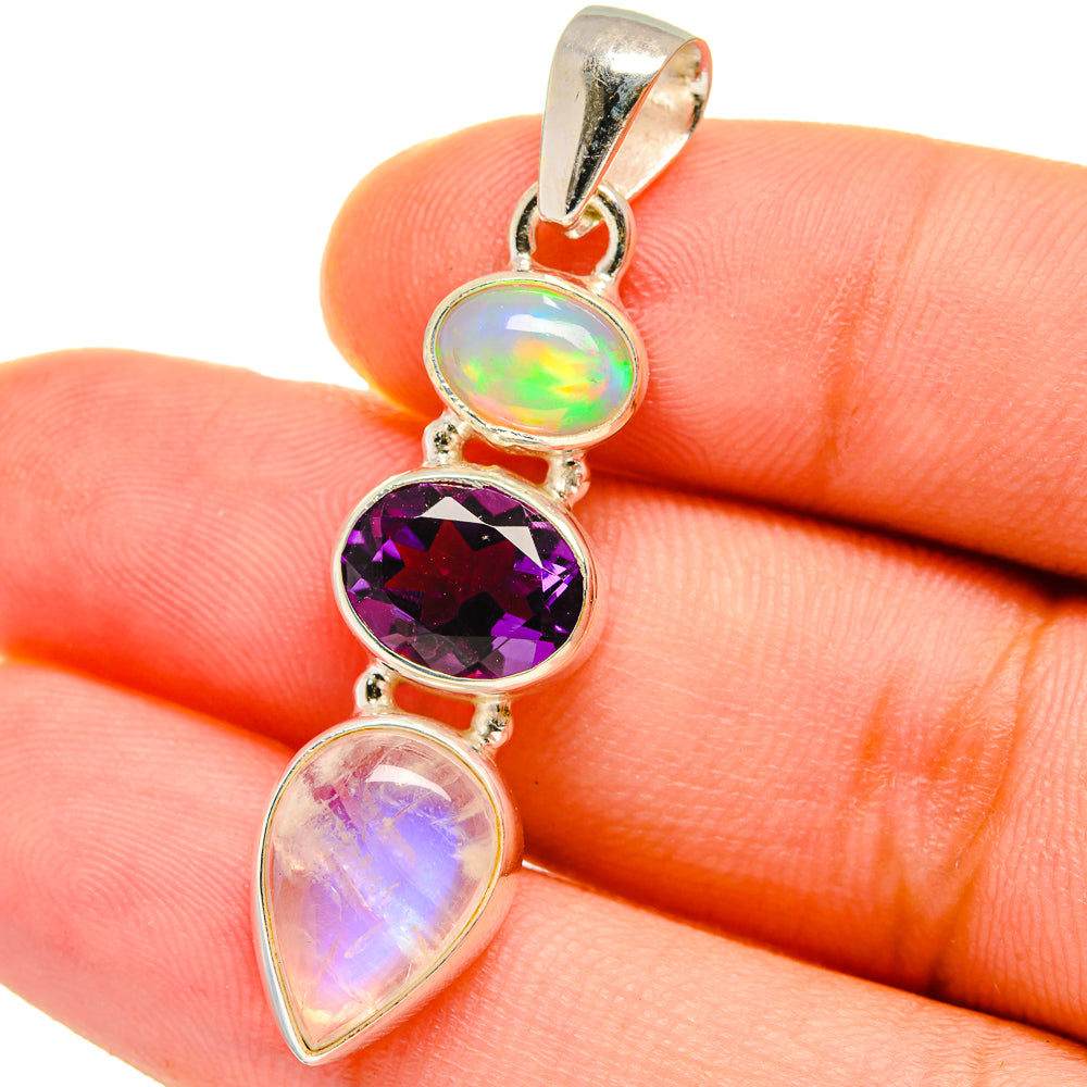 Silver-tone pendant close-up with iridescent opal, purple amethyst, and pale teardrop stone