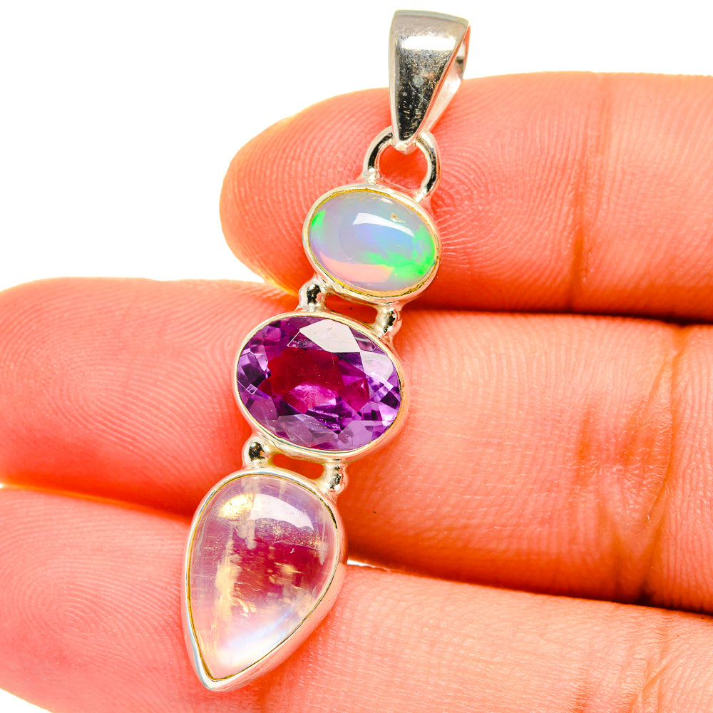 Sterling silver pendant close-up with rainbow opal top, purple oval, and white teardrop