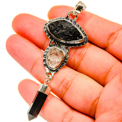 Sterling silver pendant with black teardrop stone, clear bezel stone, black crystal point