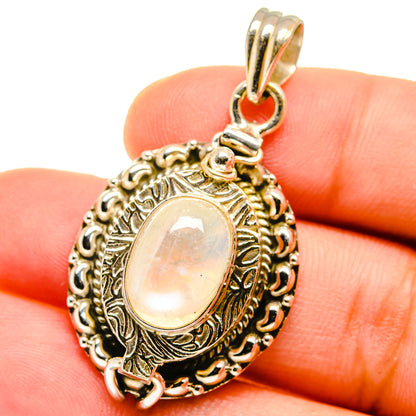 Sterling silver moonstone pendant, oval iridescent stone in decorative frame with hinge bail