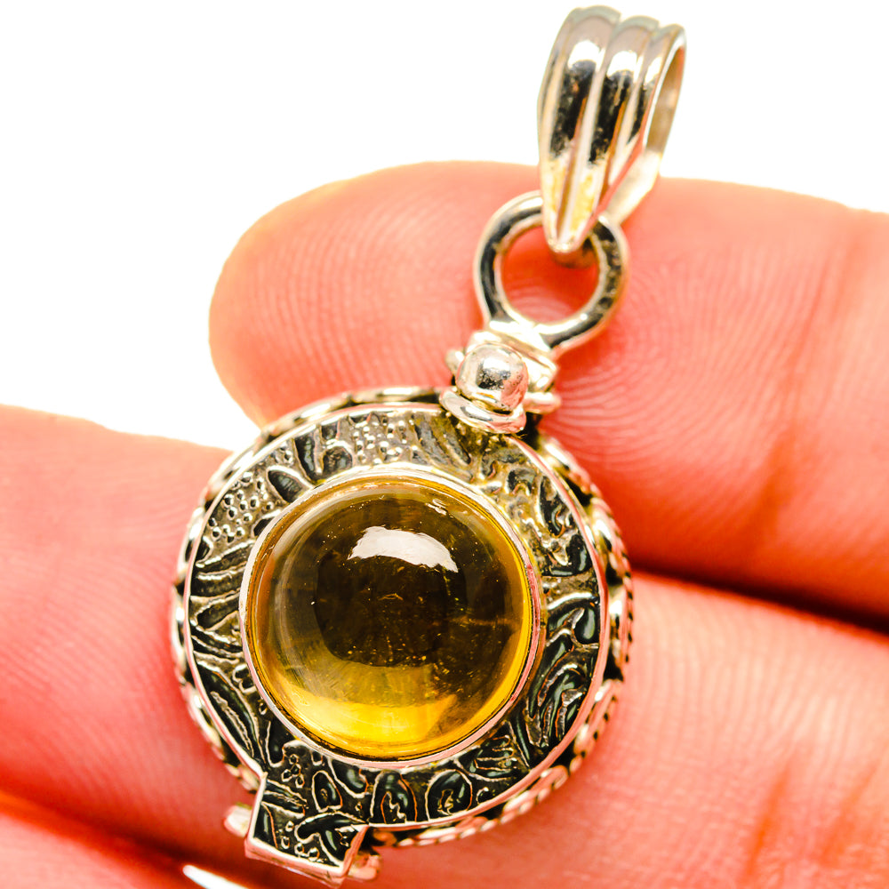 Sterling silver citrine pendant close-up with round amber gemstone and top bail