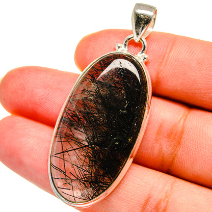 Sterling silver oval pendant with tourmalinated quartz and black needle inclusions, bail loop