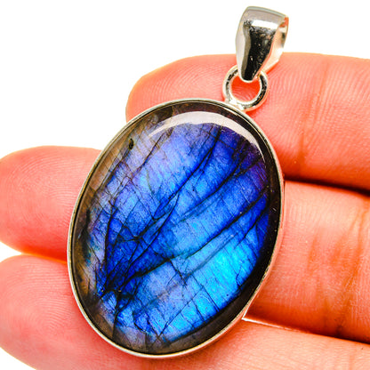 Labradorite oval pendant with blue flash in silver bezel, hinged bail