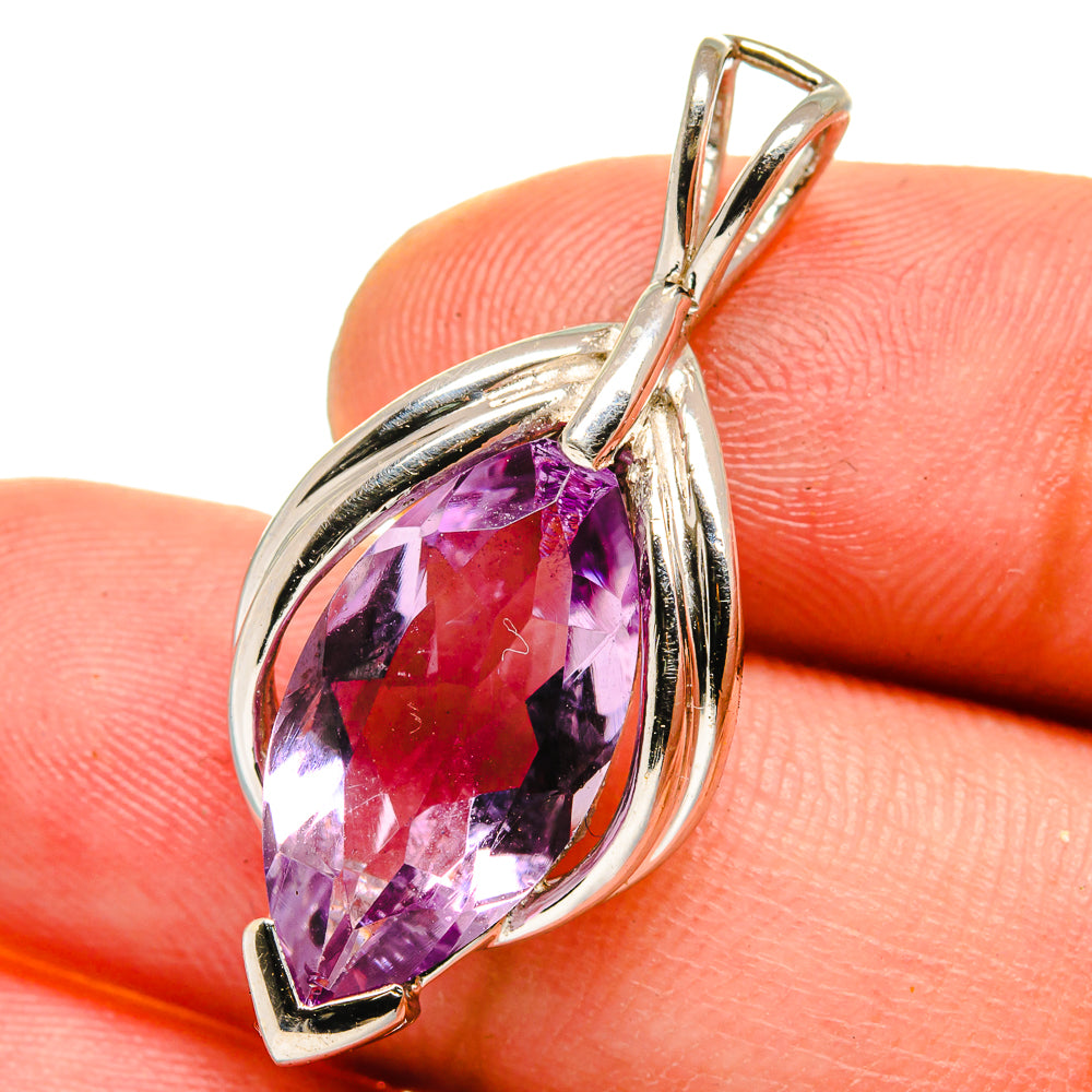 Sterling silver amethyst pendant close-up with faceted purple oval stone in frame