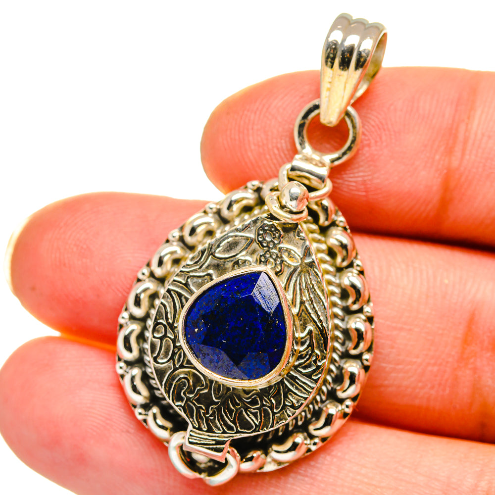 Sterling silver lapis lazuli pendant with blue teardrop cabochon center and ornate frame
