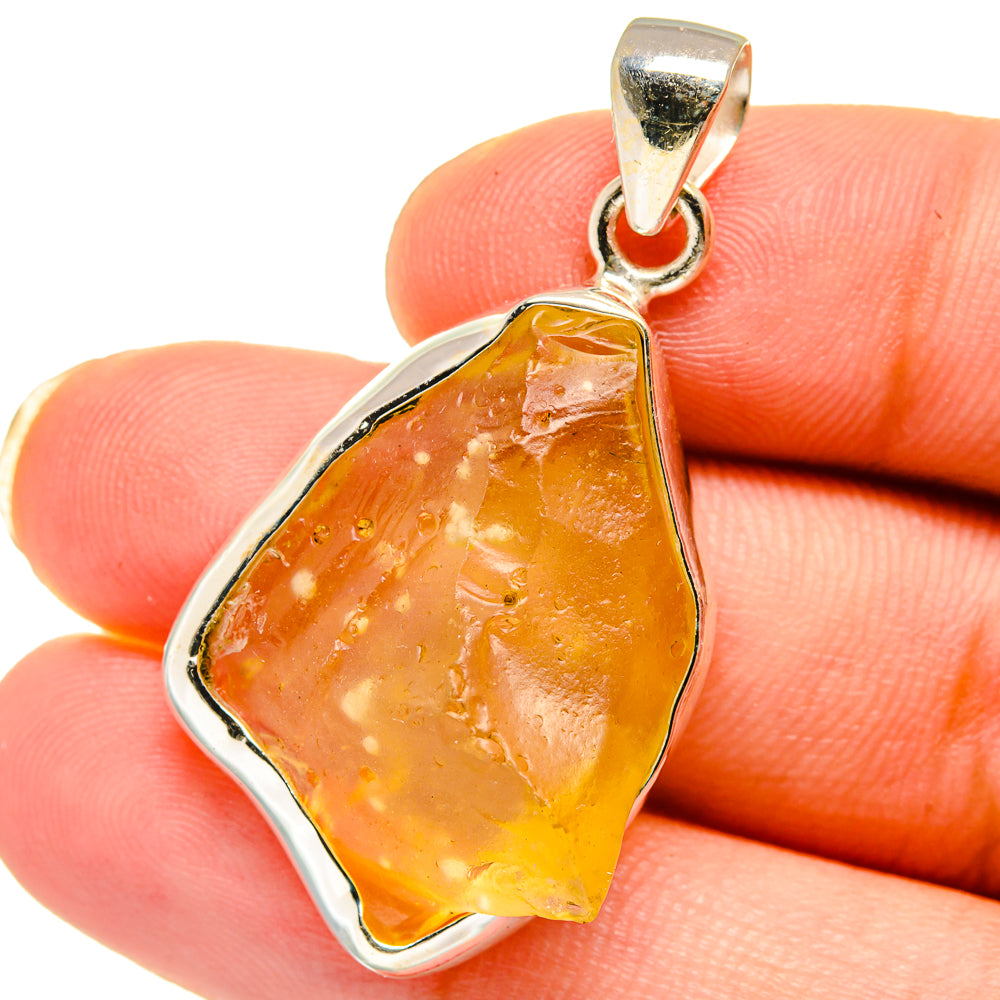 Sterling silver pendant with amber teardrop glass and loop bail in silver frame