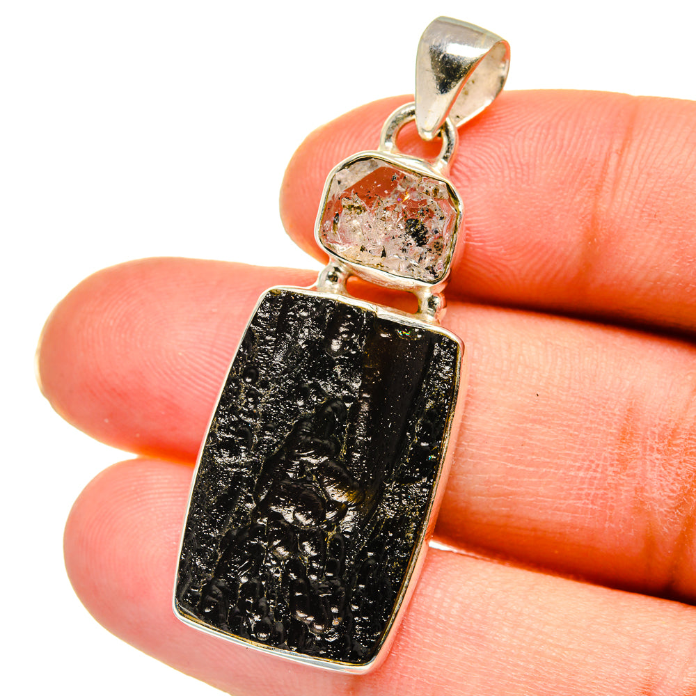 Sterling silver pendant with dark black and gold rectangular stone, close-up bail top