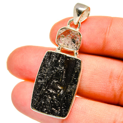 Sterling silver pendant with dark black and gold rectangular stone, close-up bail top