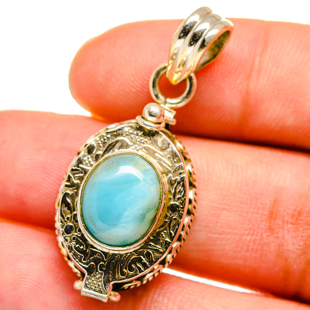 Sterling silver larimar-style drop pendant with ornate frame and blue oval stone