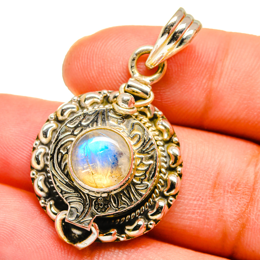Ornate silver moonstone pendant with round bezel and rainbow blue flash