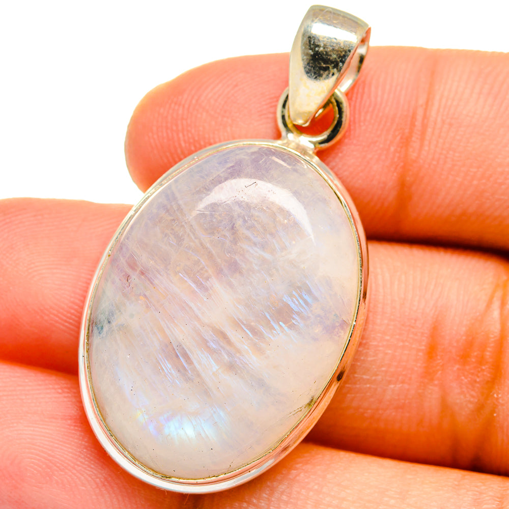 Oval moonstone pendant with rainbow sheen and gold-tone bezel on 925 silver bail