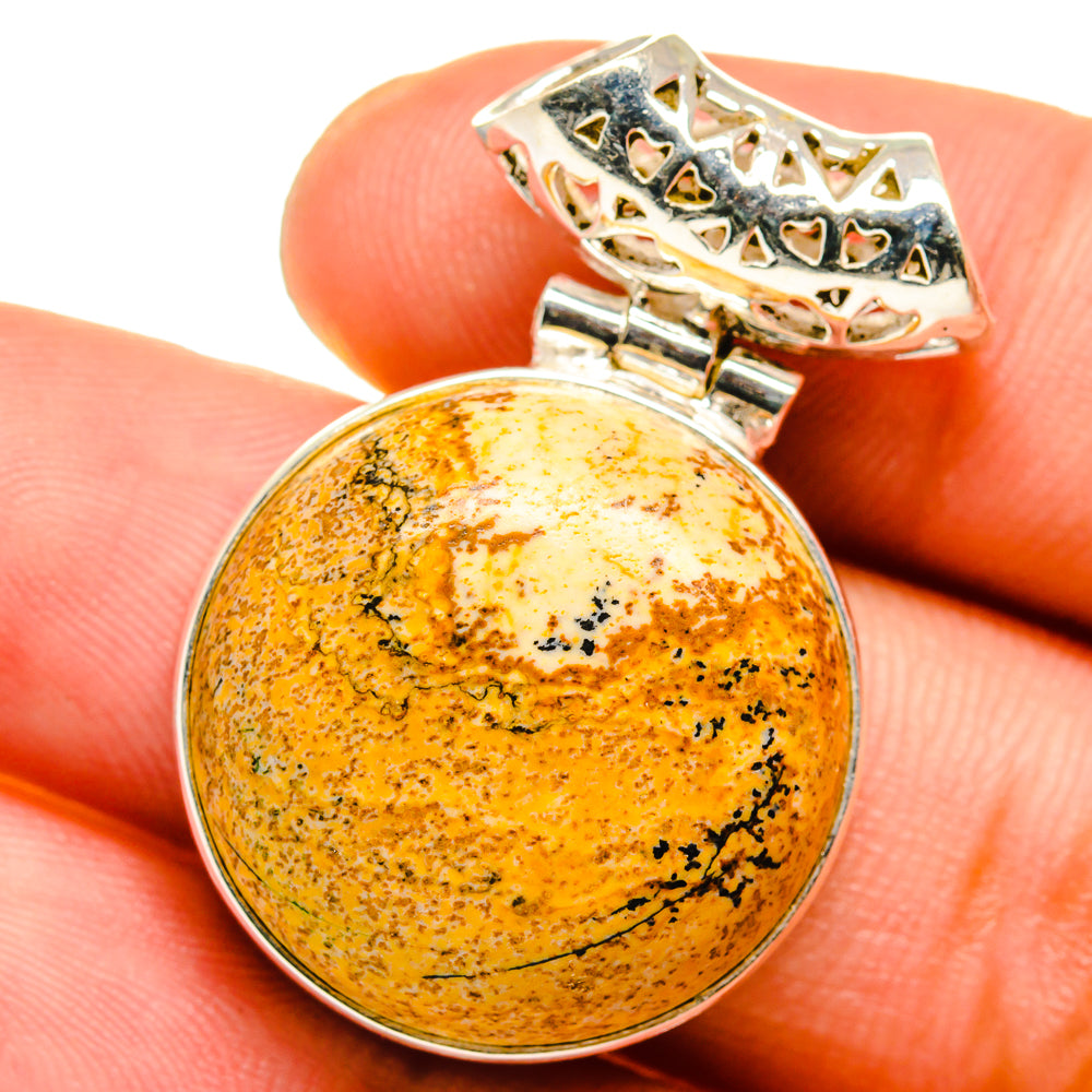 Round 925 sterling silver picture jasper pendant on finger, orange speckled cabochon