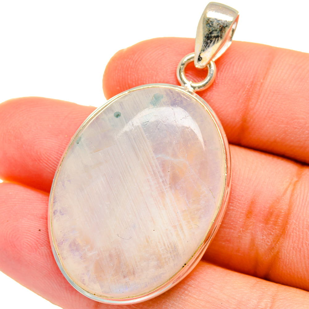 Oval moonstone pendant in sterling silver bezel with teardrop bail and iridescent light stone.