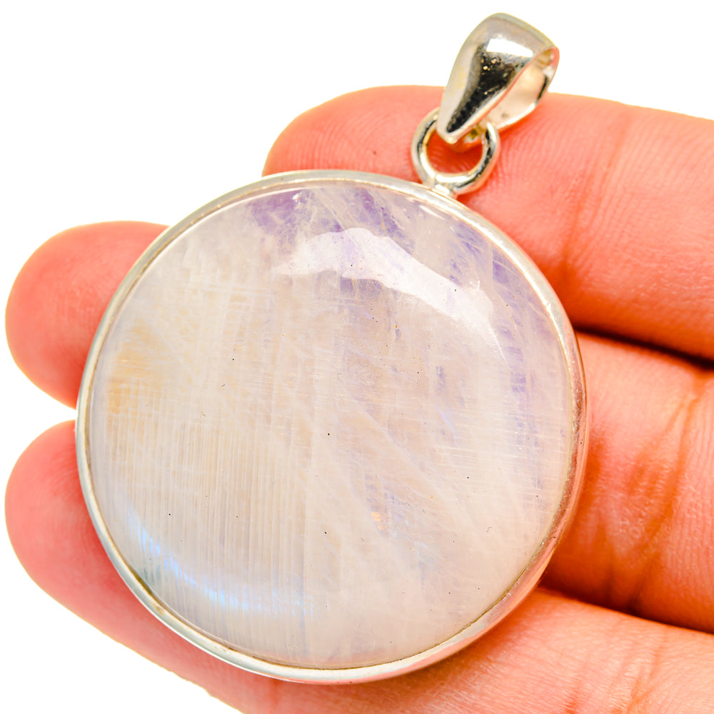 Oval moonstone cabochon pendant in silver-tone bezel with rounded bail