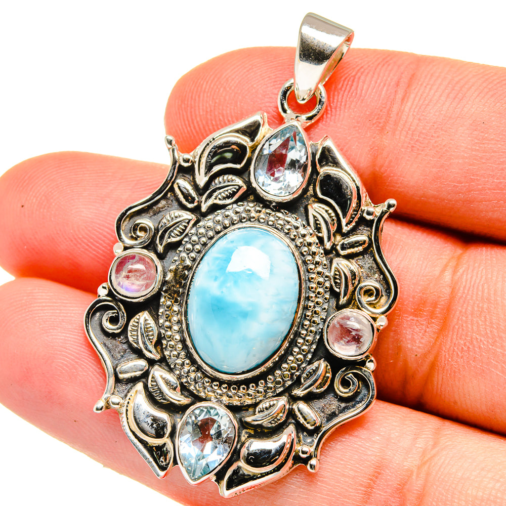 Oval blue larimar center pendant with blue stones and sterling silver filigree border